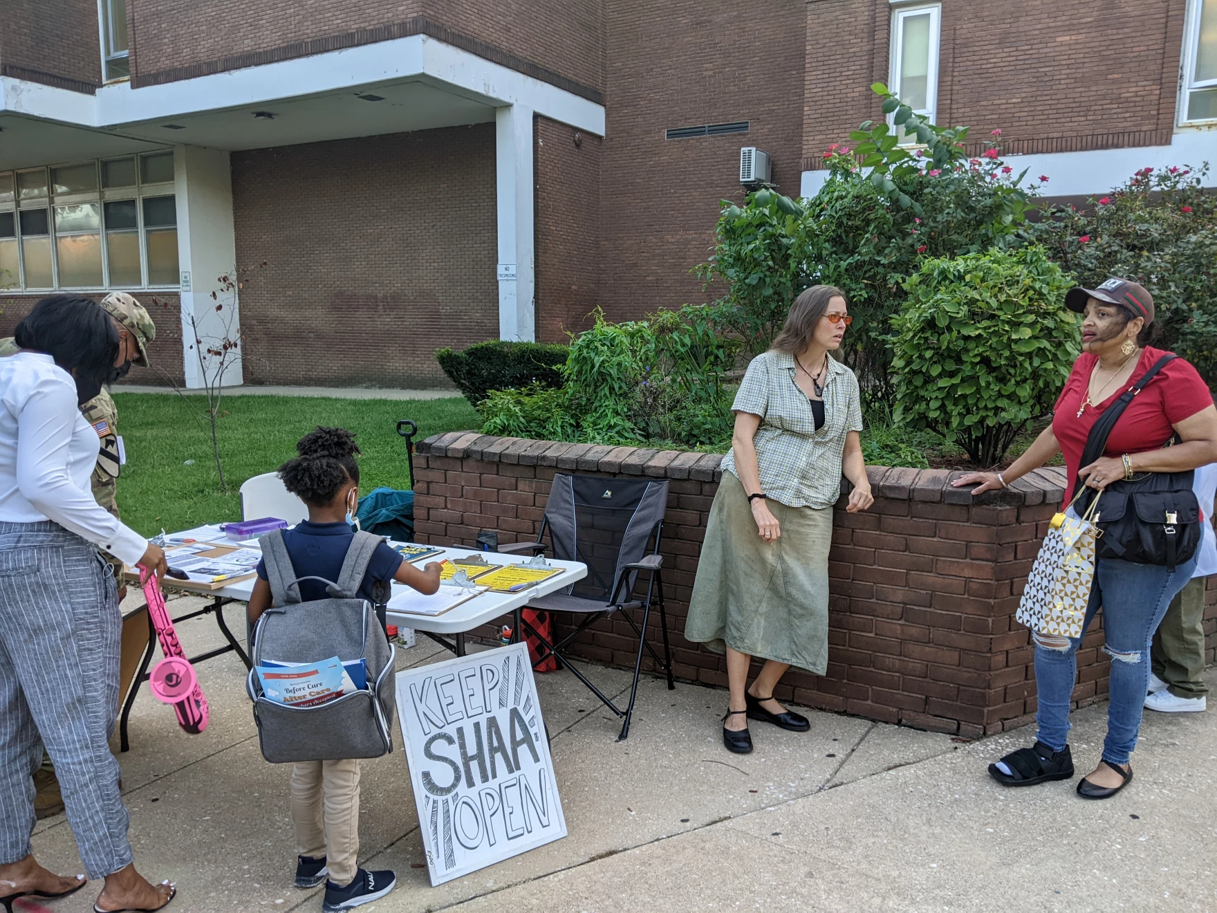 Parents, teachers and students gather in front of an elementary school that is slated to close in Baltimore, Md.