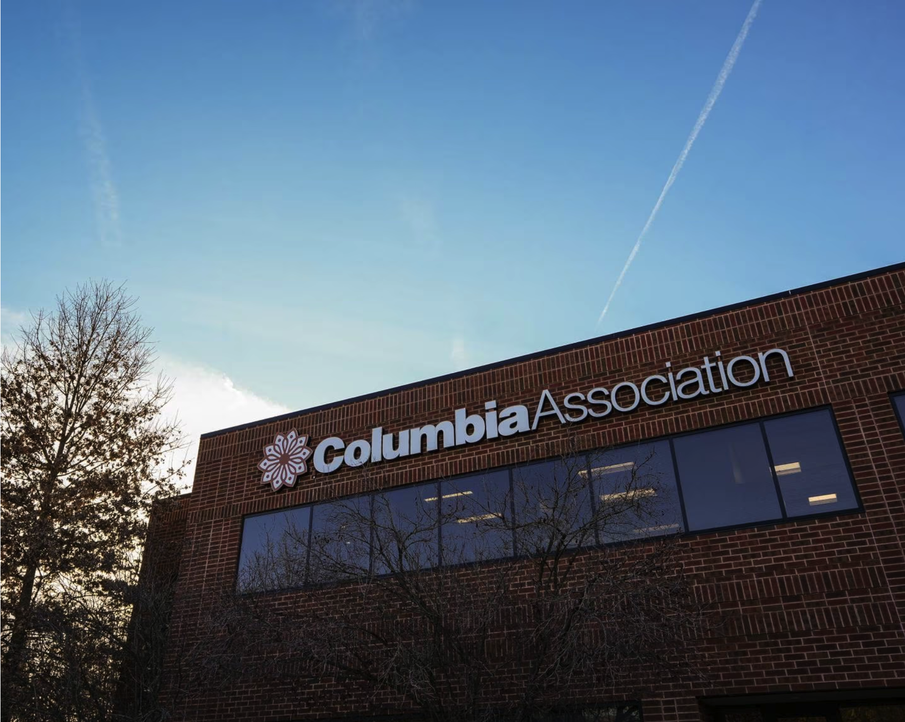 A photo of the Columbia Association office with blue sky in the background.