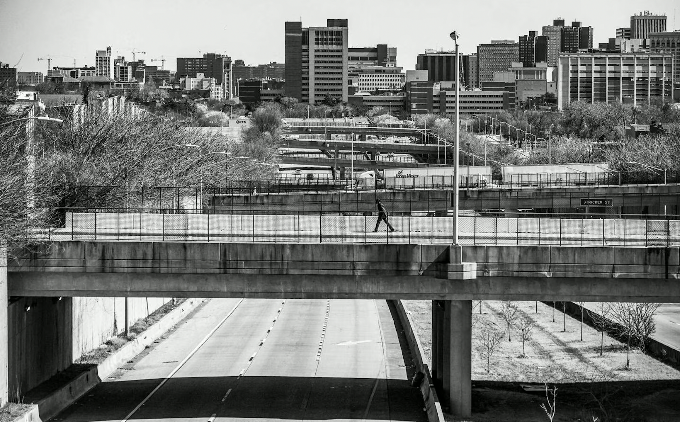 A pedestrian pass over a bridge above U.S. Route 40 in Baltimore on Wednesday, March 8, 2023.